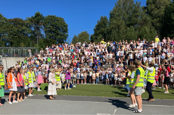 En stor gruppe mennesker i en skolegård
